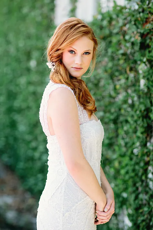 Bride in a lace gown in a white room