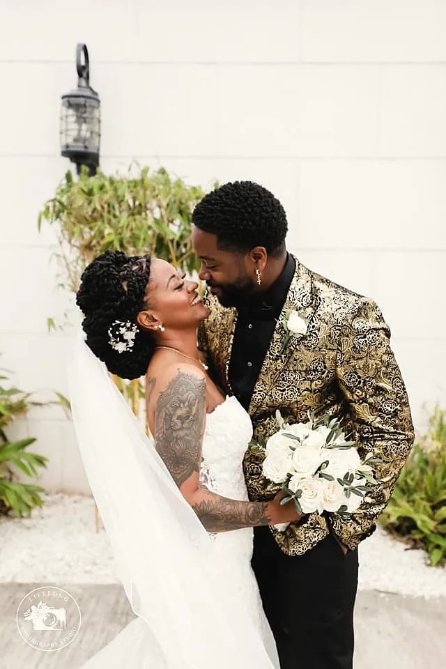 Couple kissing outside a white chapel
