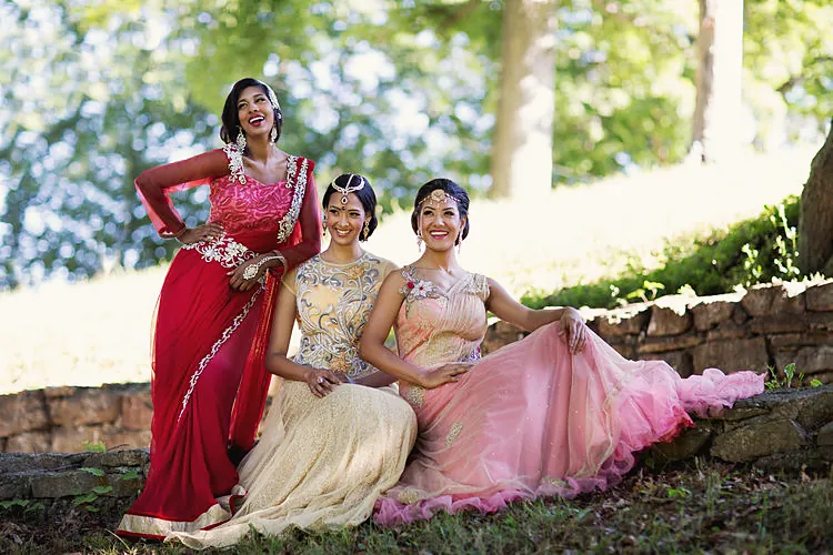 Bride and bridesmaids in saris in a garden