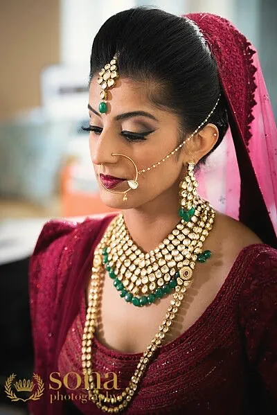 Bride with red dupatta and gold choker