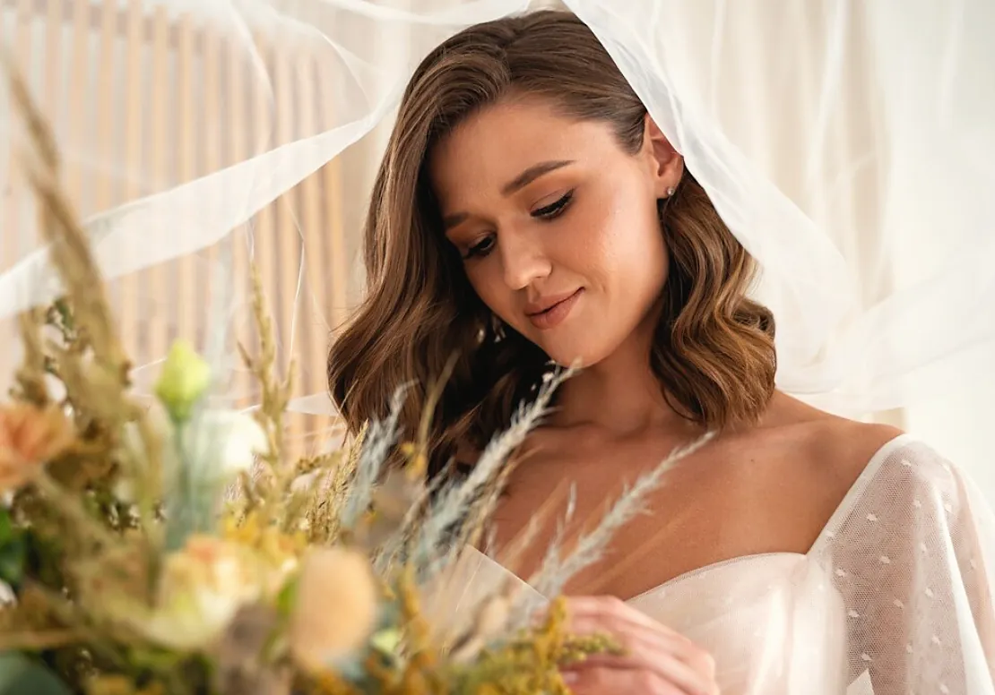 Bride with a veil in a field