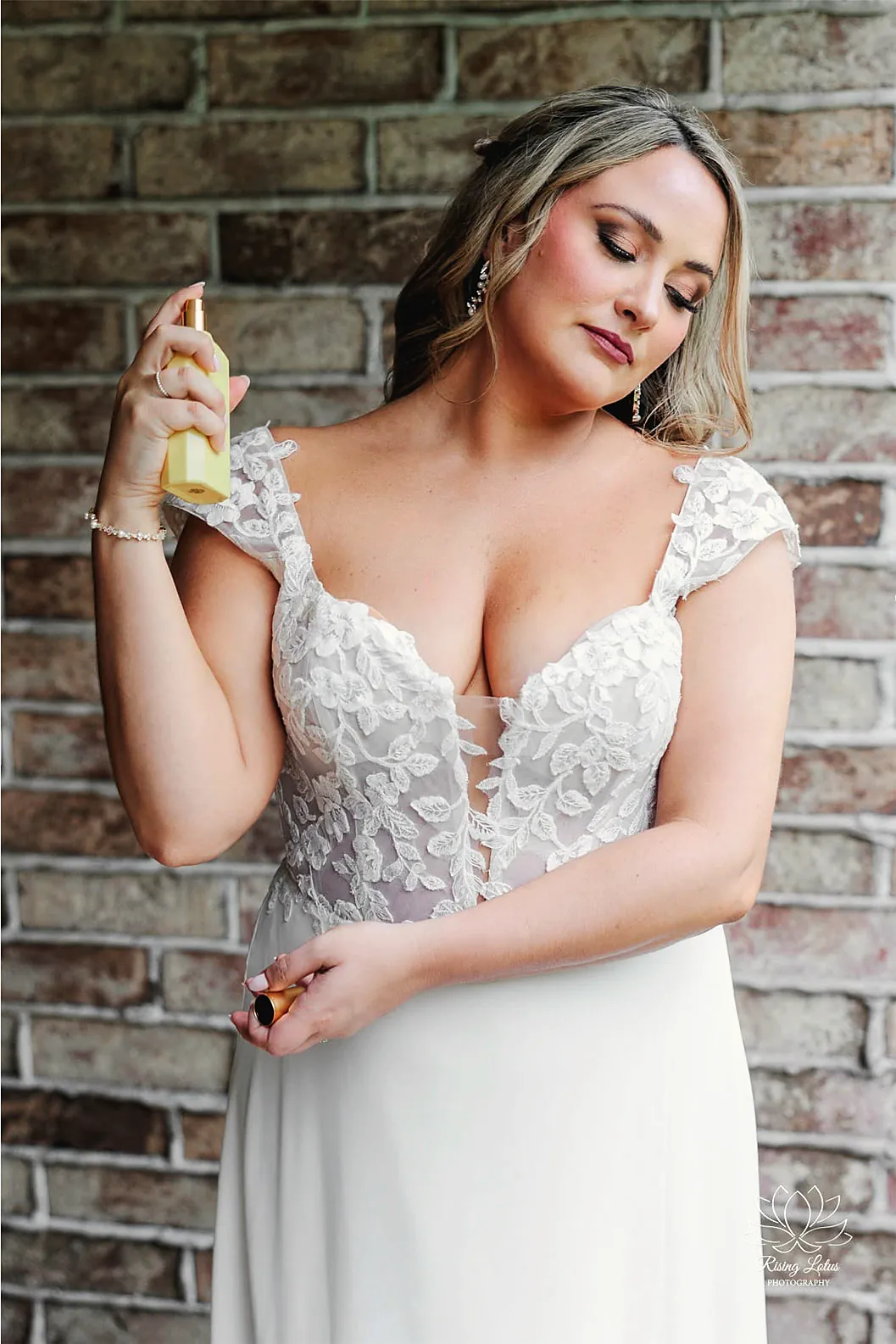 Bride in lace against a brick wall